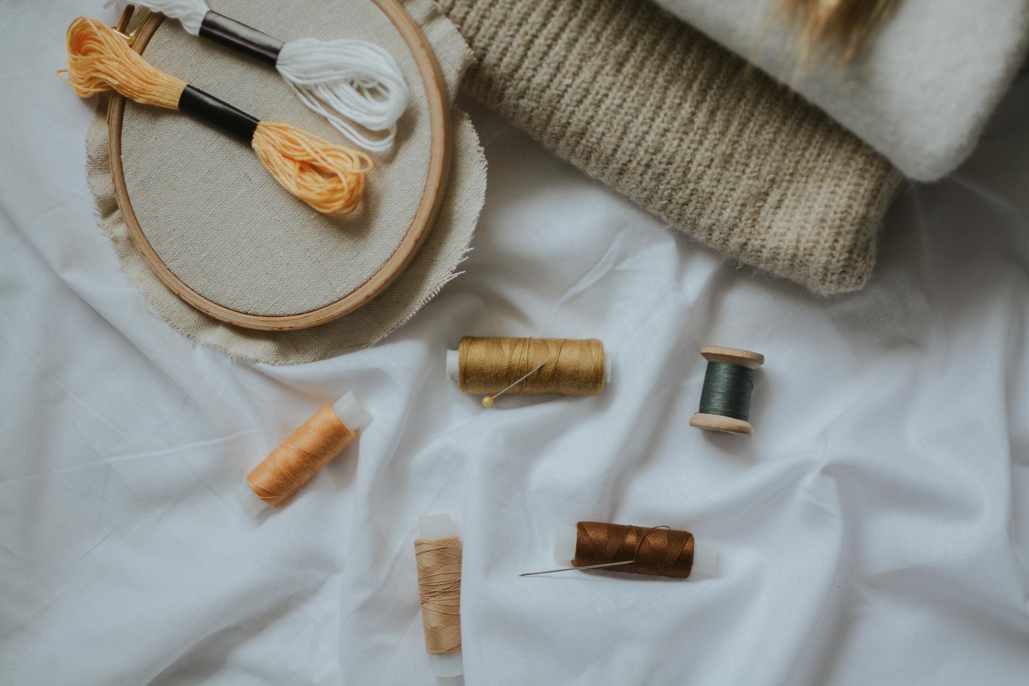 atelier table with threads and needles, natural light
