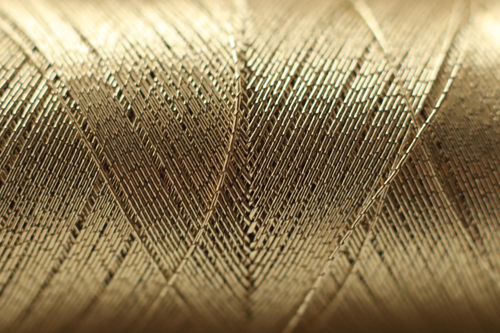 close-up of luxury embroidered textile with gold thread